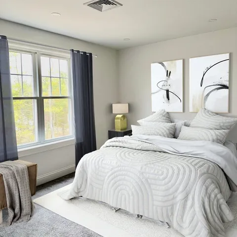 a bedroom with a bed and a large window