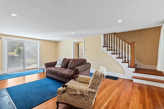a living room with furniture and a floor to ceiling window
