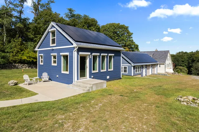 a front view of a house with yard and green space