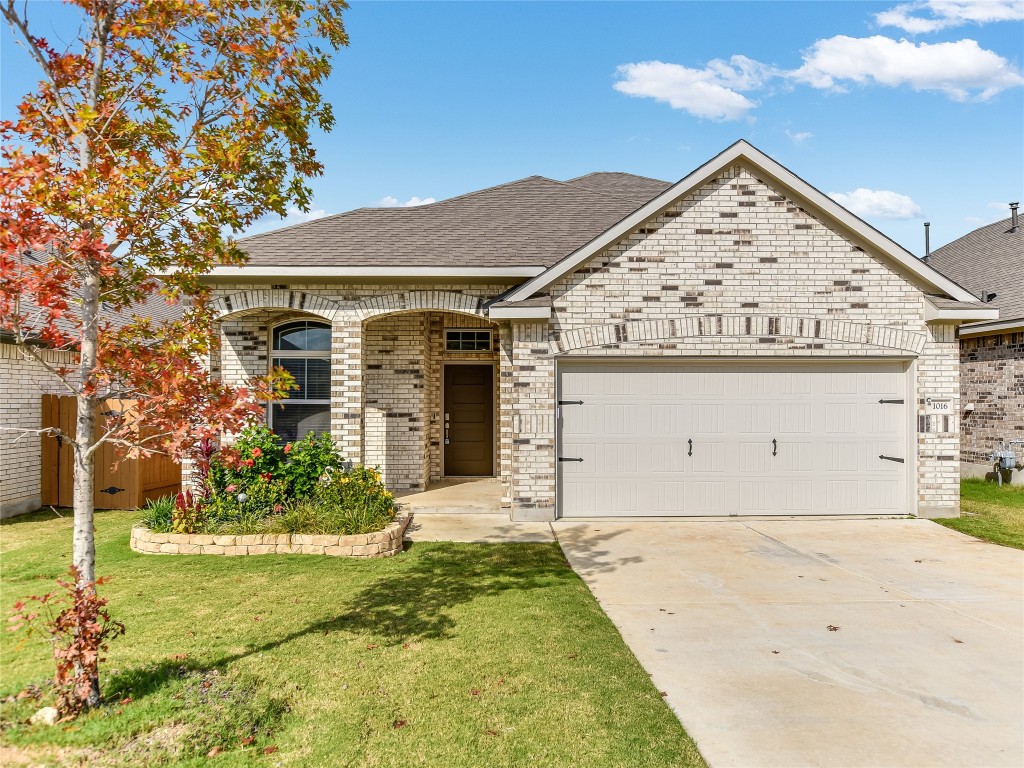 1016 Paddock Lane Georgetown, TX 78626 - Photo 1 of 25 a front view of a house with garden