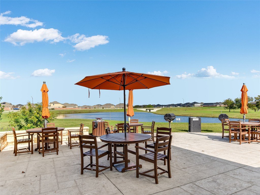 1016 Paddock Lane Georgetown, TX 78626 - Photo 14 of 25 a view of a patio with a table and chairs under an umbrella