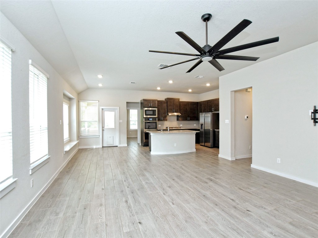 1016 Paddock Lane Georgetown, TX 78626 - Photo 16 of 25 a view of a kitchen with a sink and wooden floor