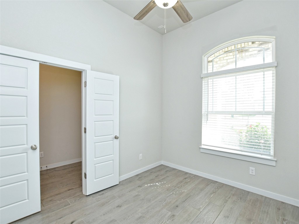 1016 Paddock Lane Georgetown, TX 78626 - Photo 25 of 25 an empty room with wooden floor closet and windows