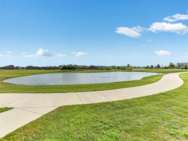 a view of a lake with houses in the back