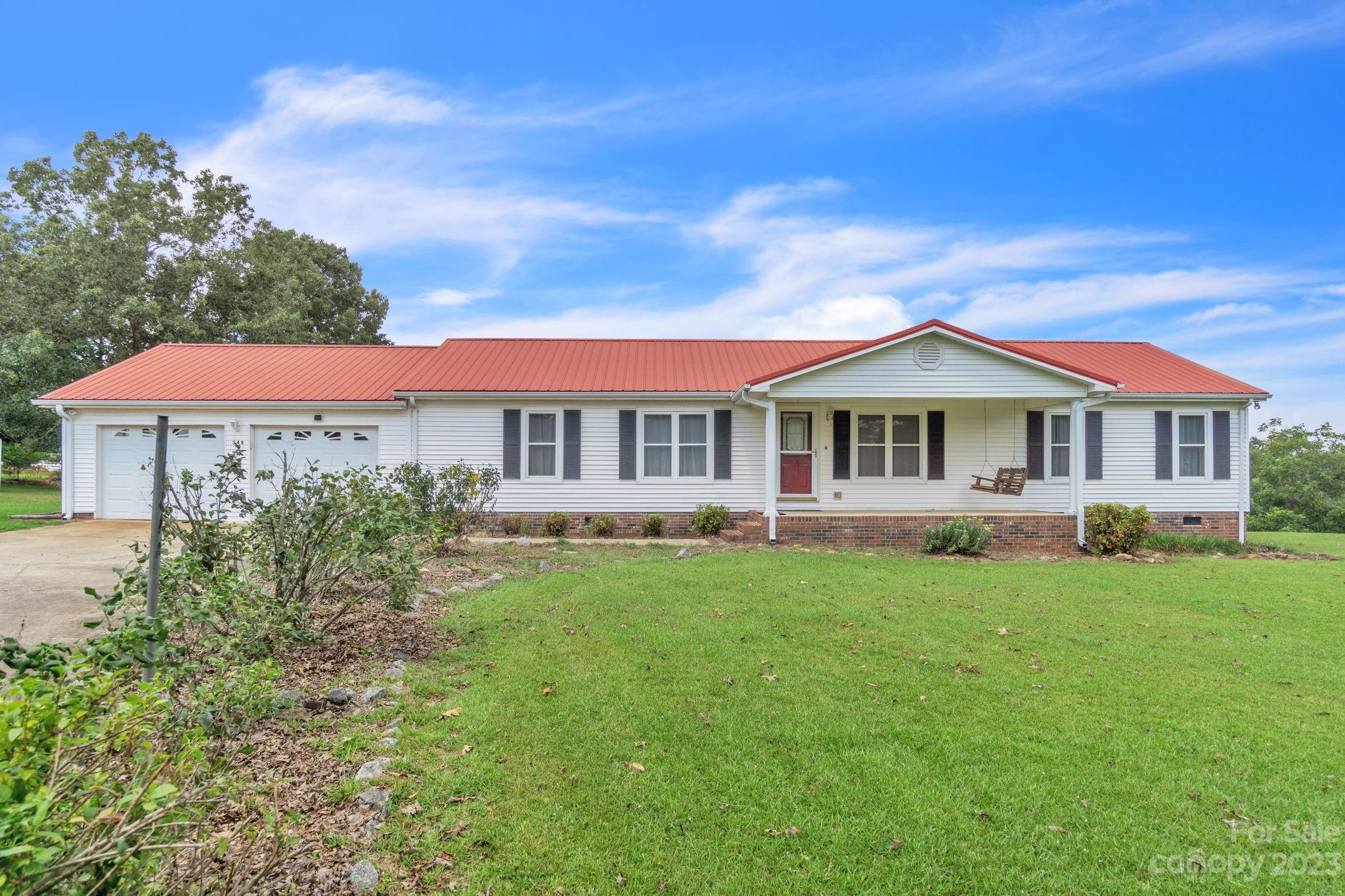 348 West V Thompson Road Rutherfordton, NC 28139 - Photo 1 of 31 a front view of a house with a garden