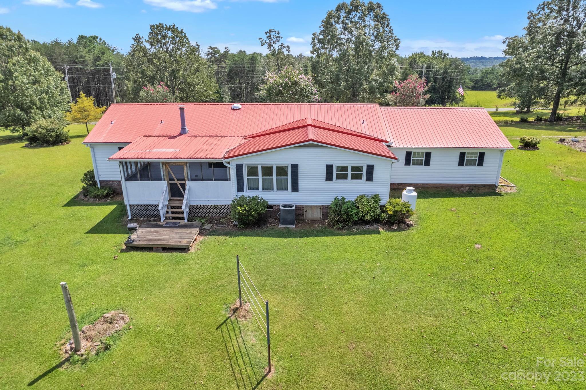 348 West V Thompson Road Rutherfordton, NC 28139 - Photo 23 of 31 a aerial view of a house with table and chairs under an umbrella