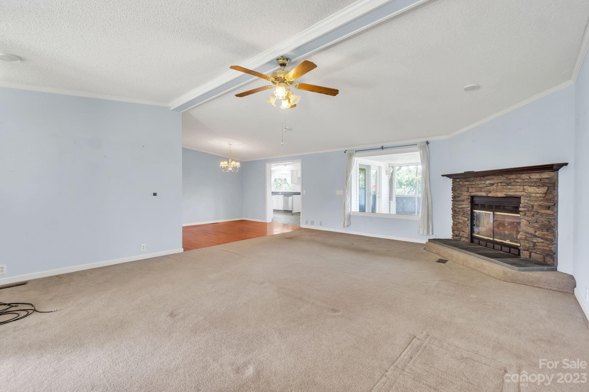 348 West V Thompson Road Rutherfordton, NC 28139 - Photo 4 of 31 an empty room with windows and fireplace