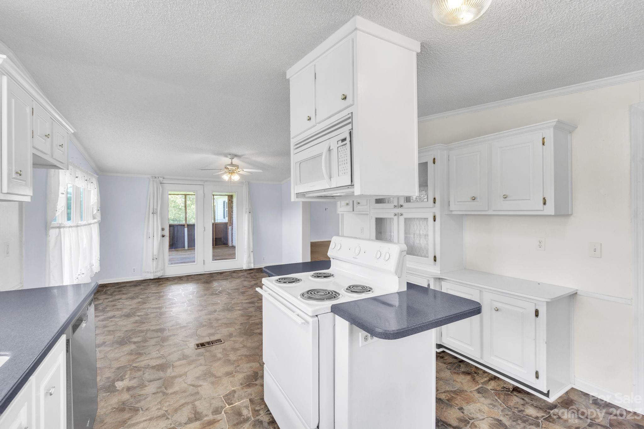 348 West V Thompson Road Rutherfordton, NC 28139 - Photo 7 of 31 a kitchen with stainless steel appliances granite countertop a sink stove and cabinets
