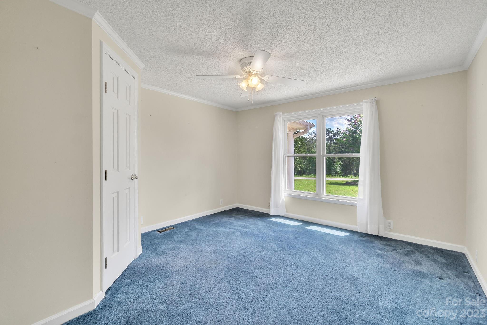 348 West V Thompson Road Rutherfordton, NC 28139 - Photo 9 of 31 an empty room with windows and fan
