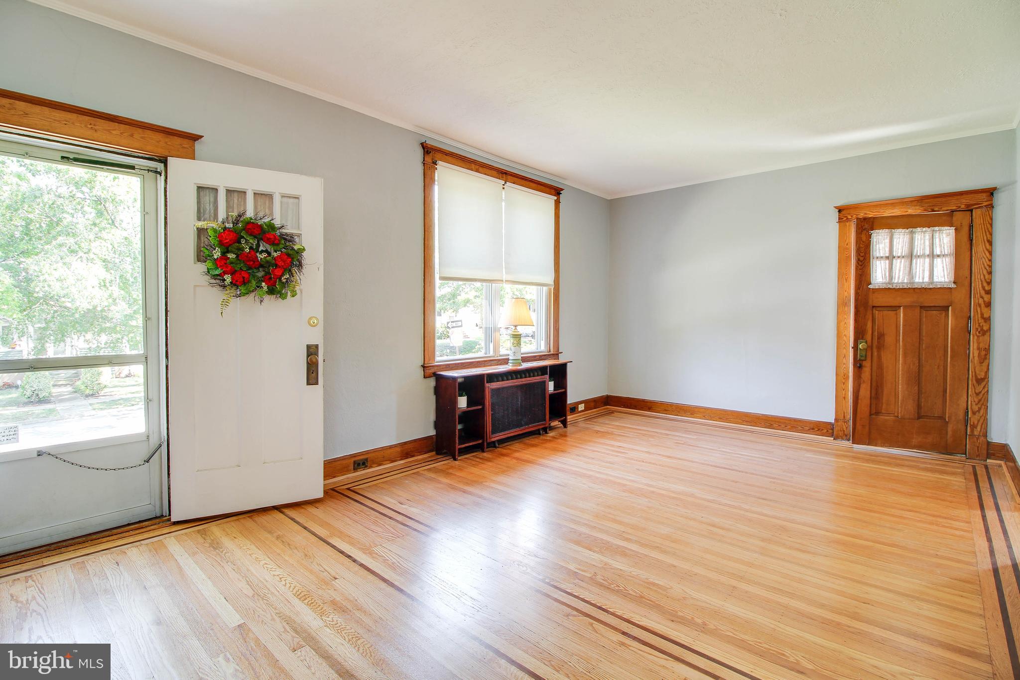 5302 Wendley Road Baltimore, MD 21229 - Photo 2 of 38 an empty room with wooden floor and windows