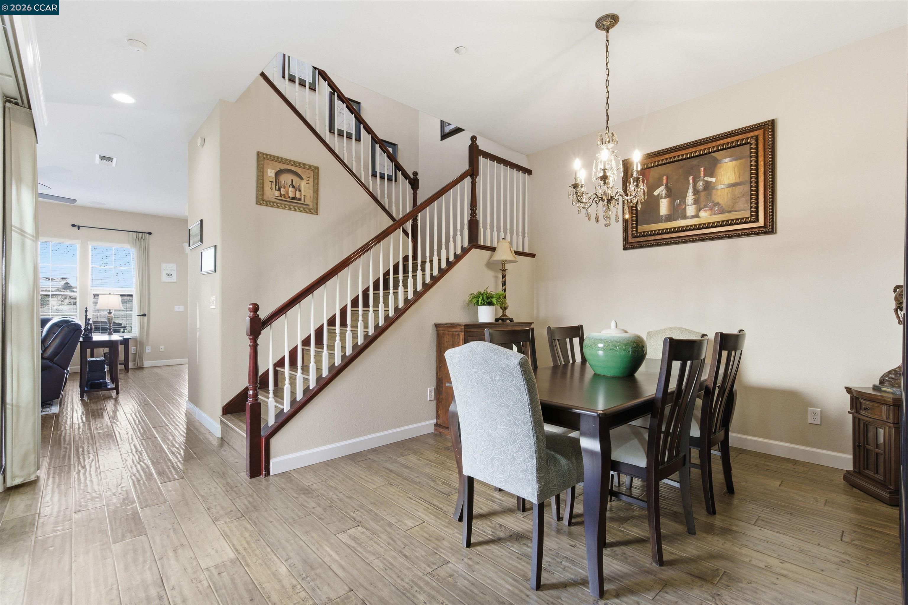 9927 Reimers Way Dublin, CA 94568 - Photo 15 of 39 a view of a dining room with furniture wooden floor and chandelier