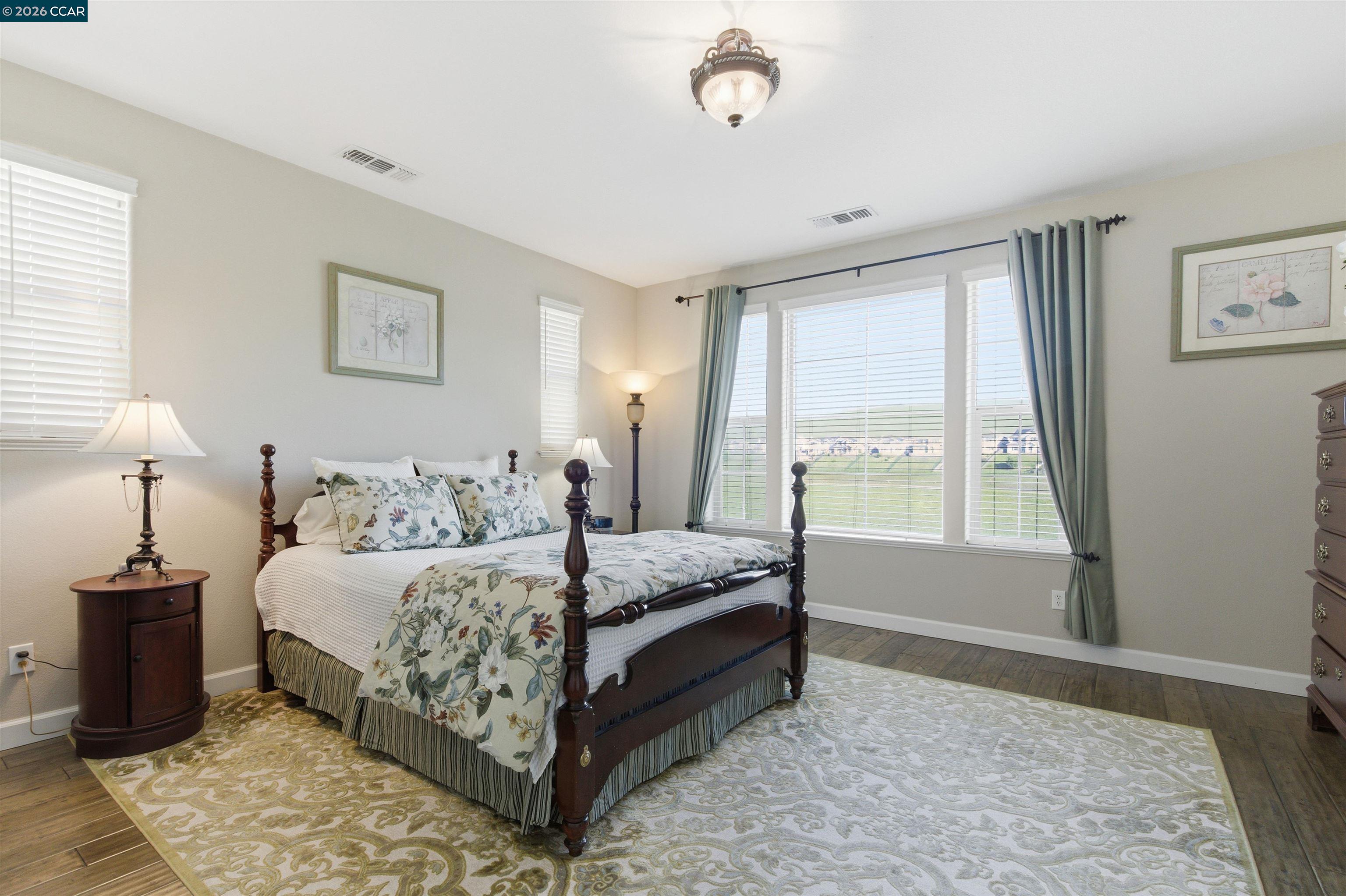 9927 Reimers Way Dublin, CA 94568 - Photo 22 of 39 a spacious bedroom with a bed and a window