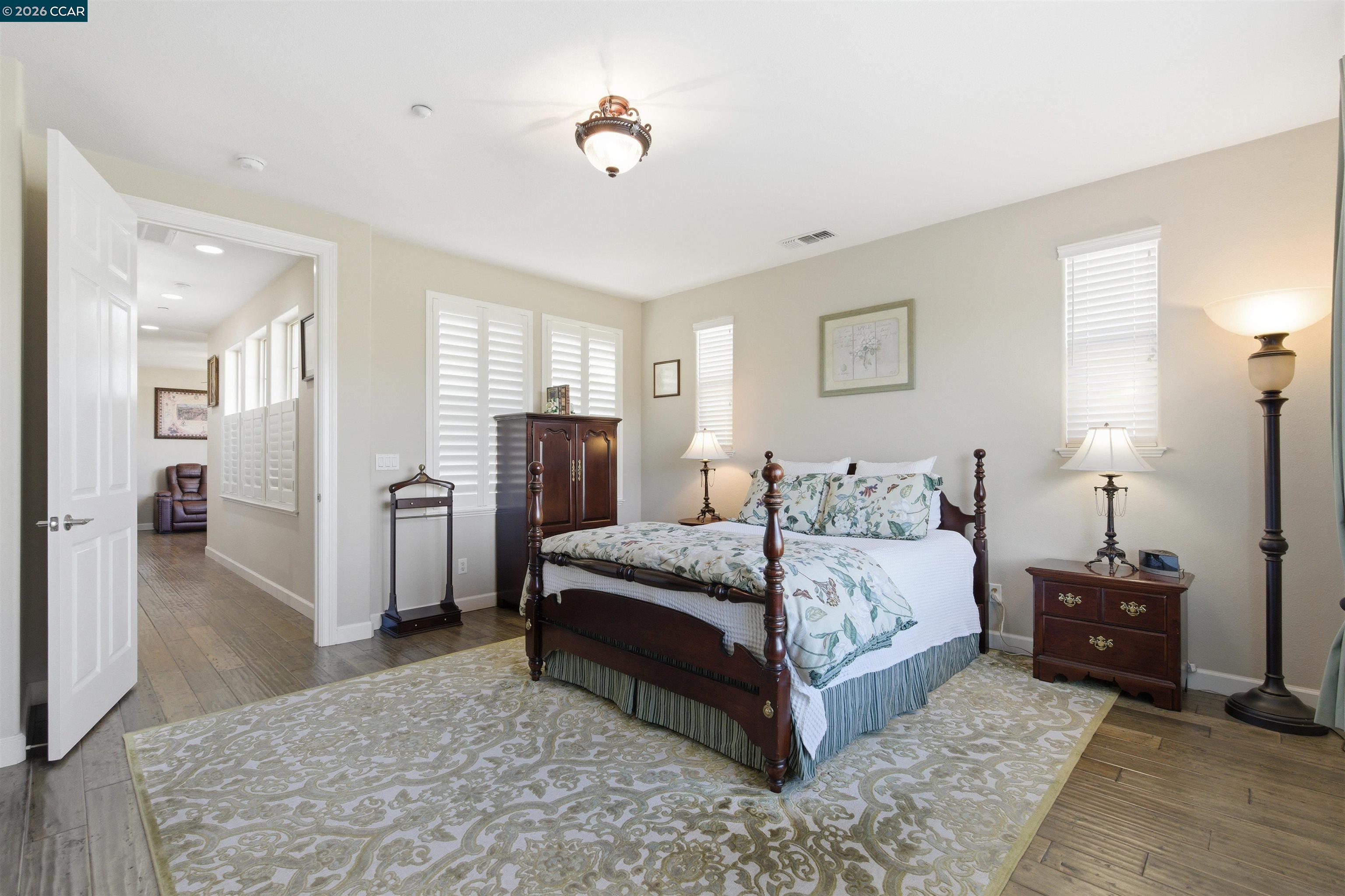 9927 Reimers Way Dublin, CA 94568 - Photo 23 of 39 a spacious bedroom with a bed and a couch