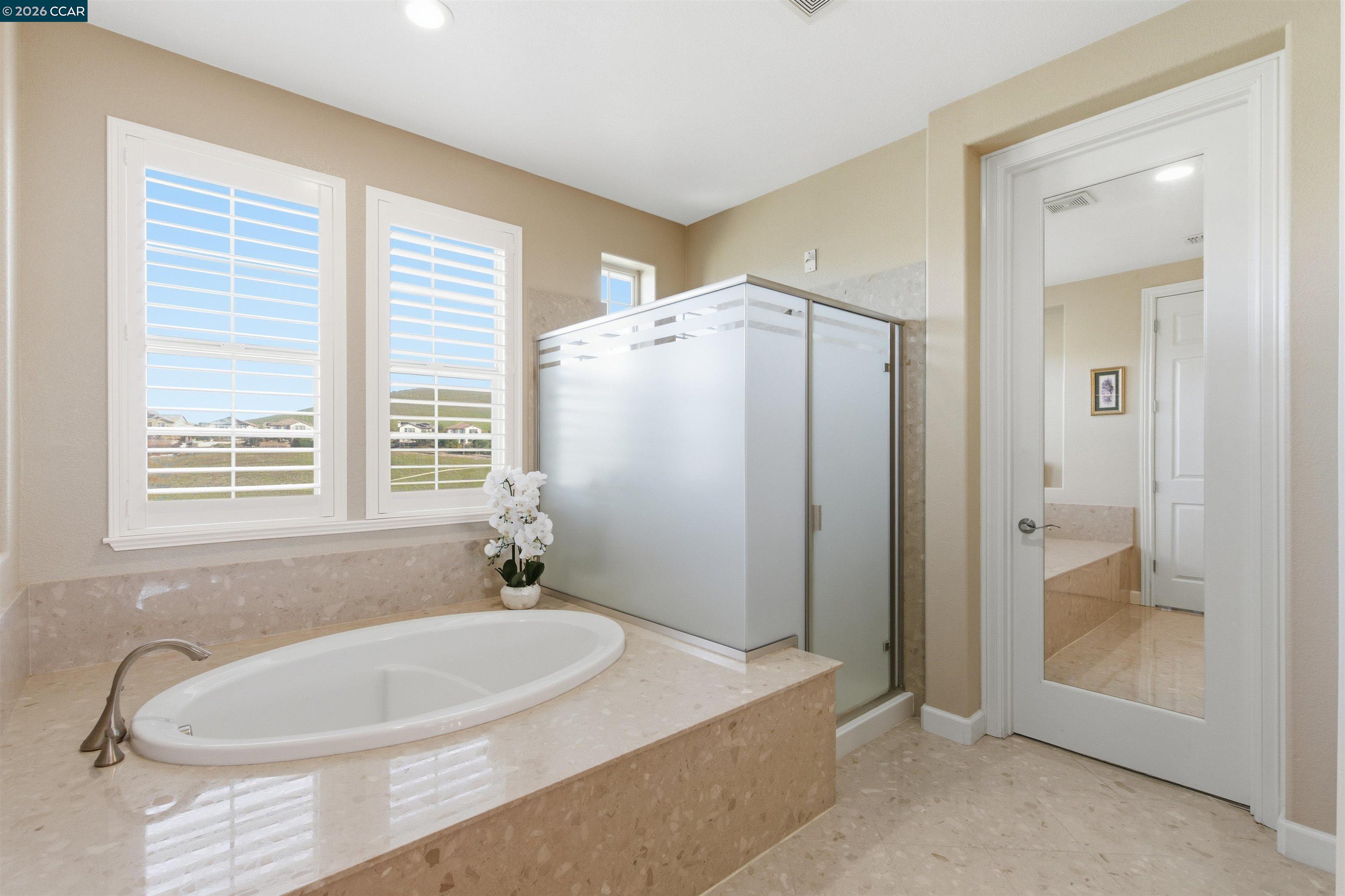 9927 Reimers Way Dublin, CA 94568 - Photo 24 of 39 a bathroom with a bathtub and a shower