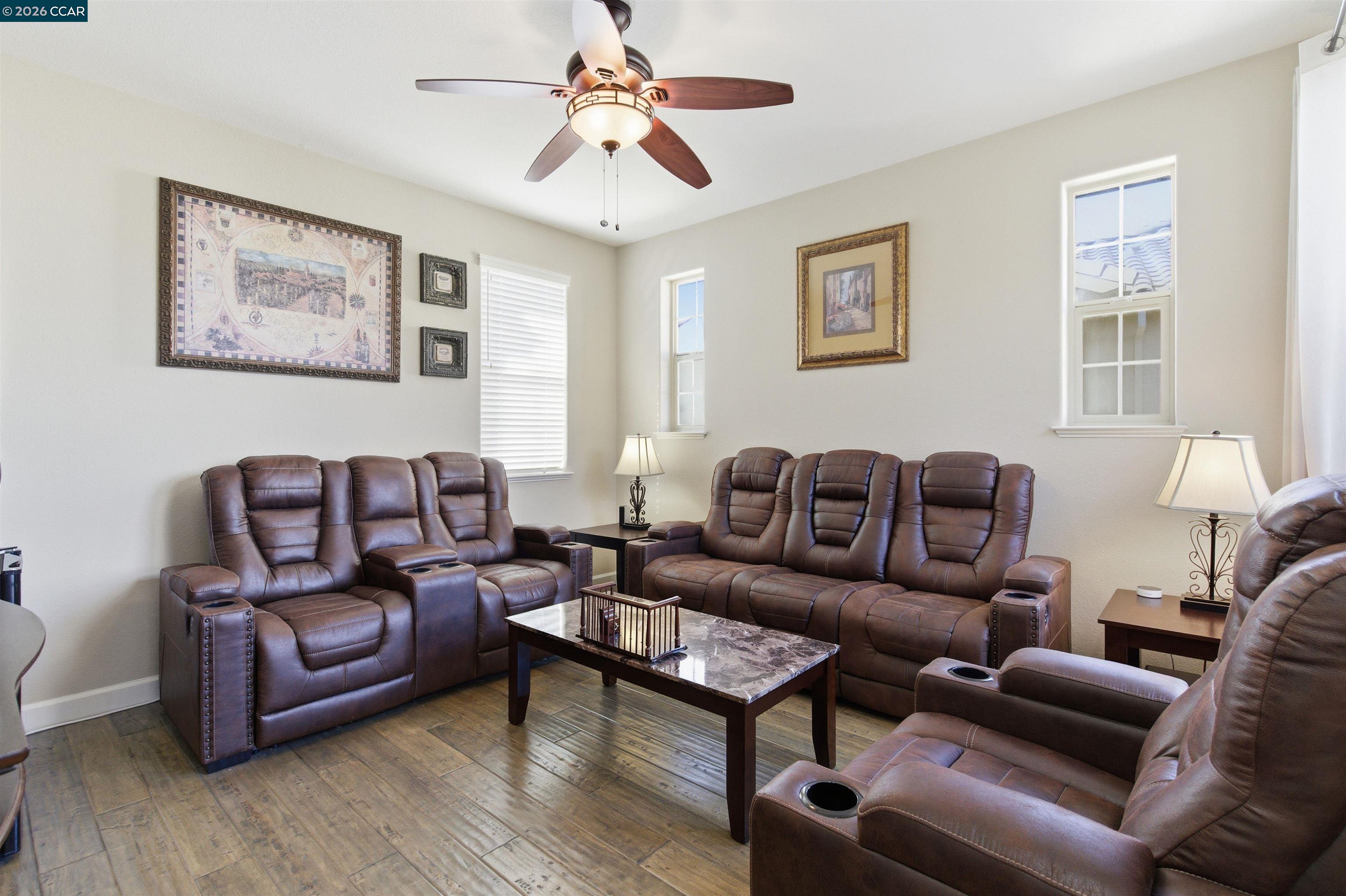 9927 Reimers Way Dublin, CA 94568 - Photo 26 of 39 a living room with furniture a couch and paintings on the wall