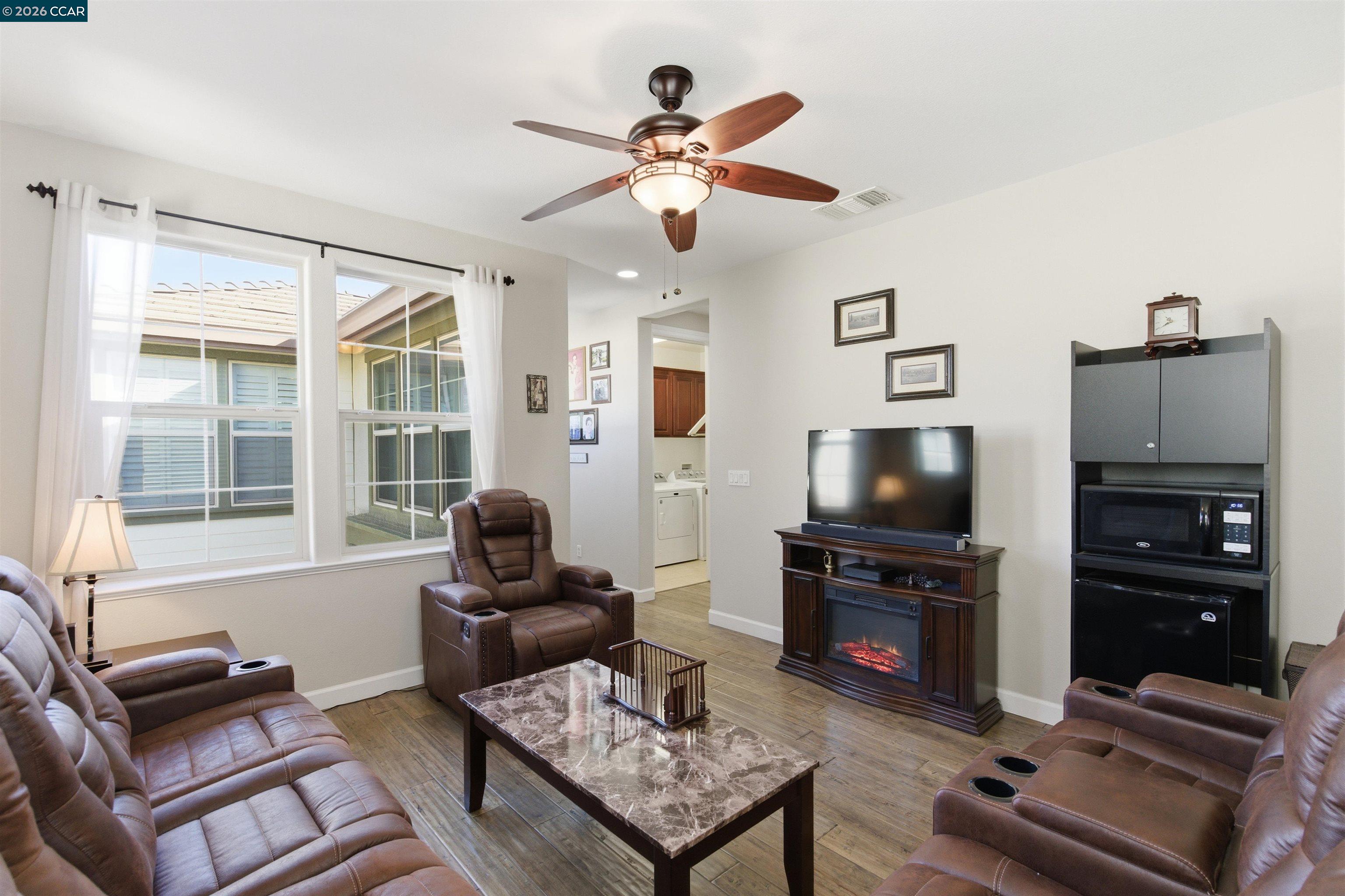 9927 Reimers Way Dublin, CA 94568 - Photo 27 of 39 a living room with furniture and a flat screen tv