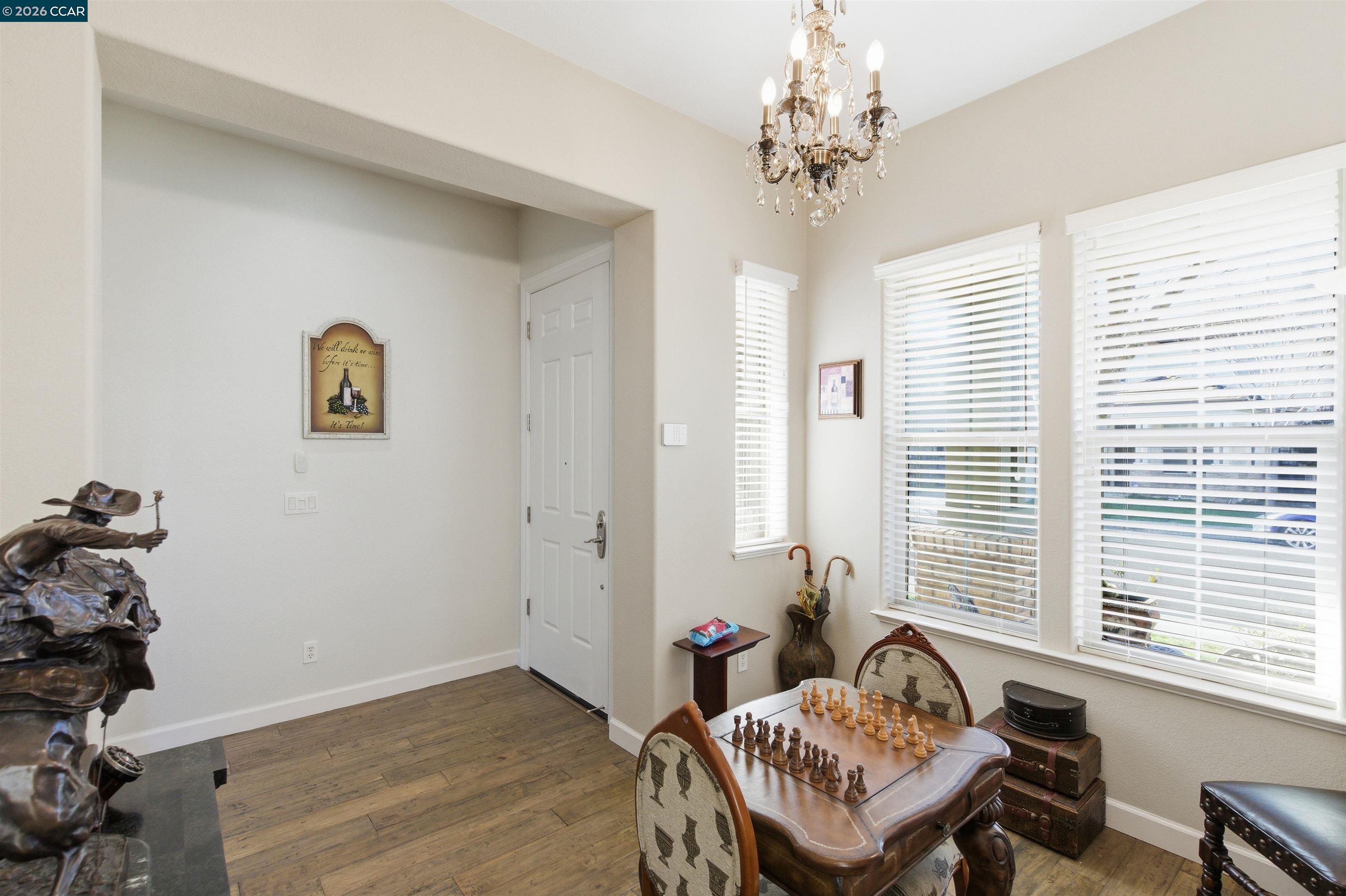 9927 Reimers Way Dublin, CA 94568 - Photo 6 of 39 a living room with furniture and a chandelier