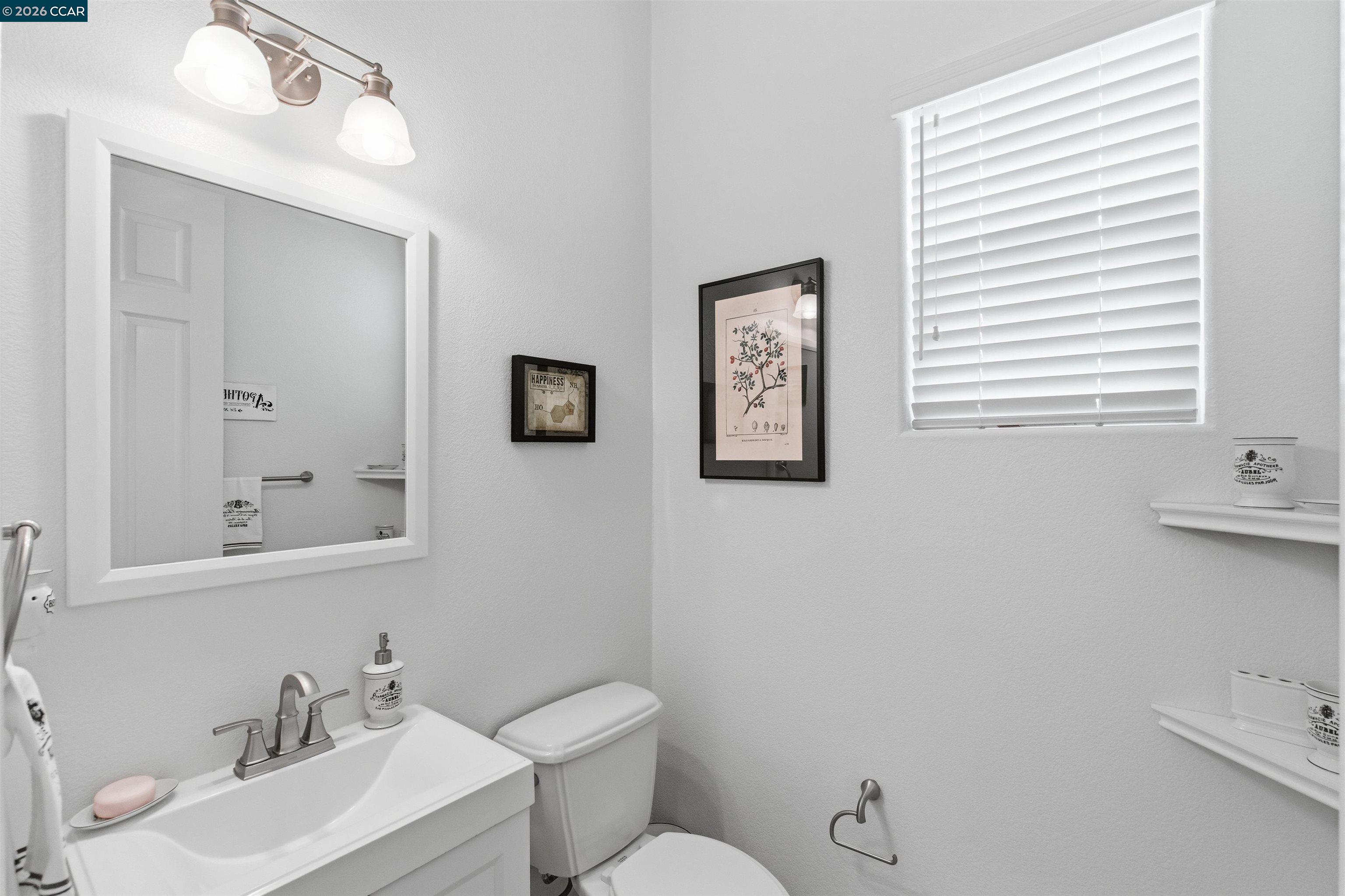9927 Reimers Way Dublin, CA 94568 - Photo 7 of 39 a bathroom with a toilet a sink and mirror