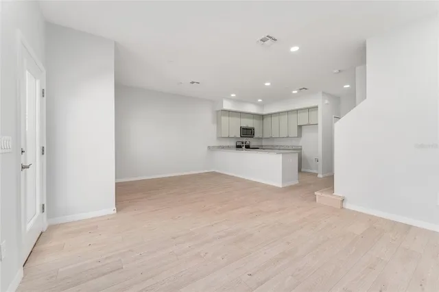 a view of a kitchen with a sink and a refrigerator