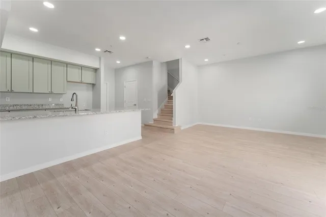 a view of a kitchen with a sink and a refrigerator