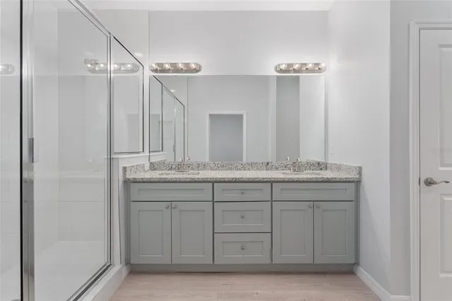 a bathroom with a granite countertop sink mirror and double