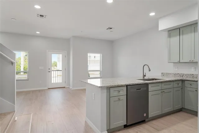a view of a kitchen sink and cabinets