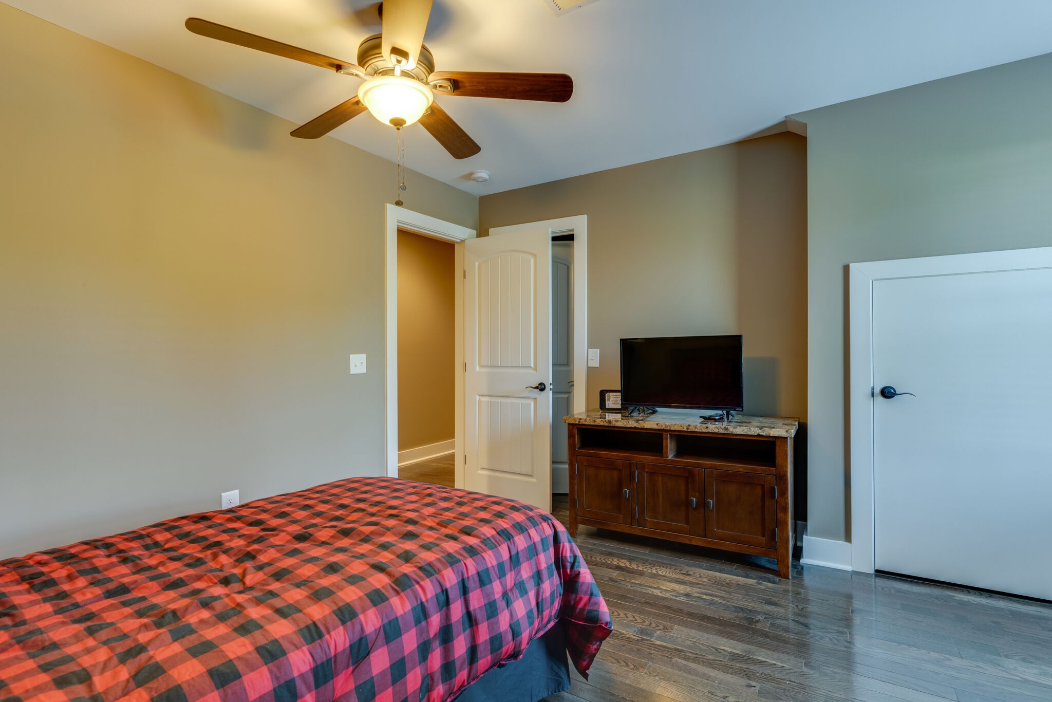 604 Fowler Ford Road Portland, TN 37148 - Photo 24 of 43 a bedroom with a bed and a flat tv screen on dresser
