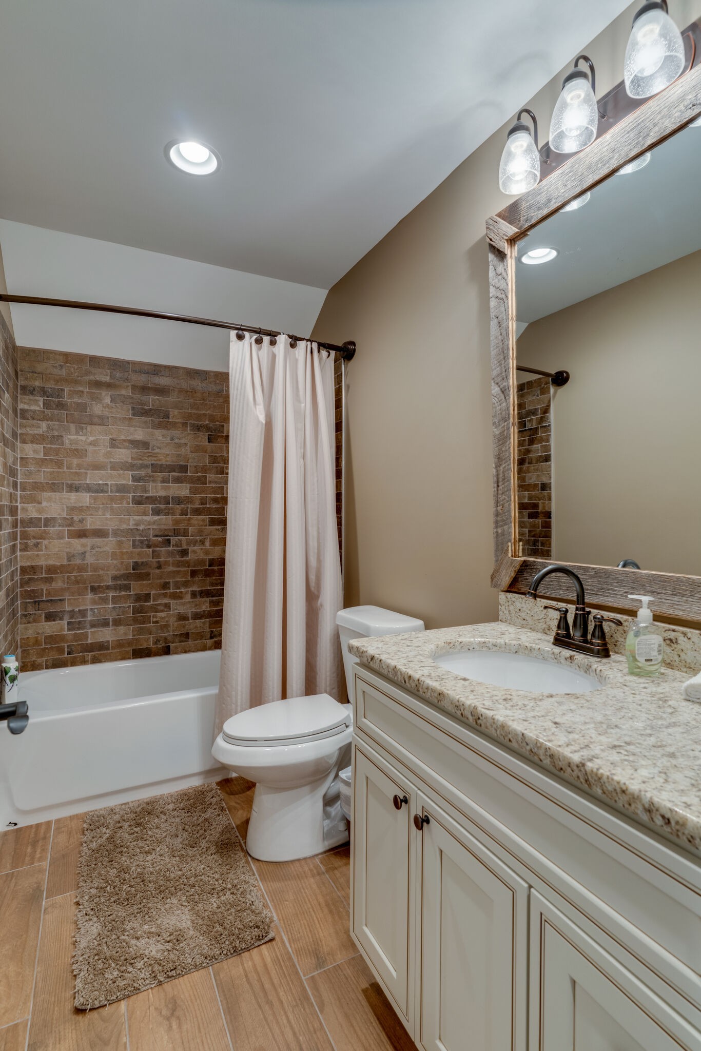 604 Fowler Ford Road Portland, TN 37148 - Photo 26 of 43 a bathroom with a granite countertop sink a toilet a mirror and bathtub