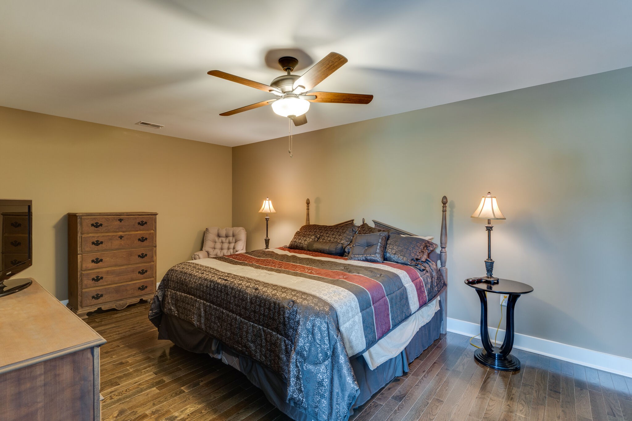 604 Fowler Ford Road Portland, TN 37148 - Photo 28 of 43 a bedroom with a bed and a chandelier