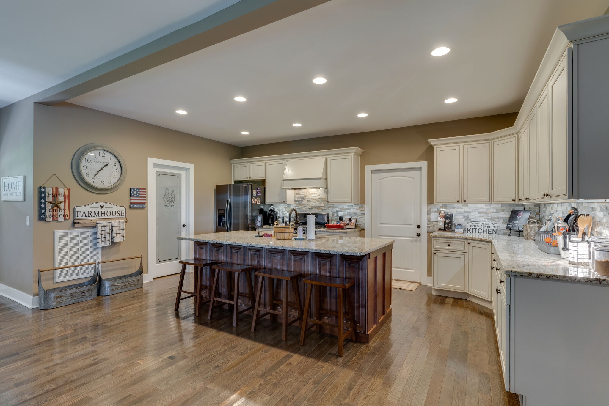 604 Fowler Ford Road Portland, TN 37148 - Photo 9 of 43 a kitchen with stainless steel appliances granite countertop wooden floors and wooden cabinets