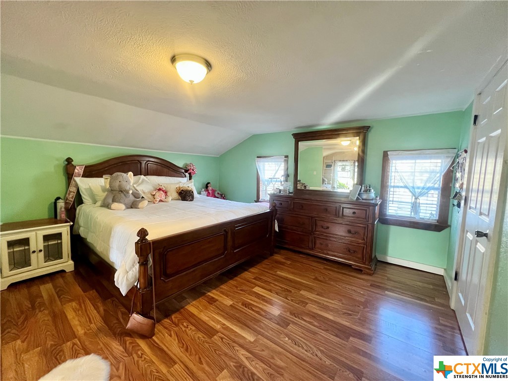 402 Dunn Street Yoakum, TX 77995 - Photo 21 of 48 a bedroom with a bed and a dresser