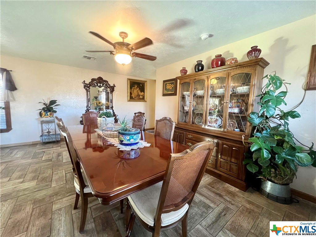 402 Dunn Street Yoakum, TX 77995 - Photo 9 of 48 a dining room with furniture potted plants and wooden floor
