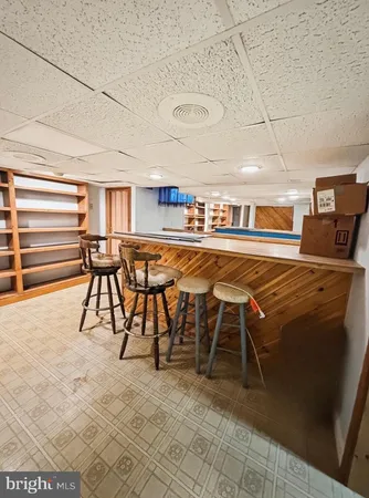 a living room with furniture a rug and a table
