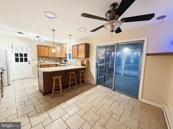 a large white kitchen with a stove a sink dishwasher and a refrigerator