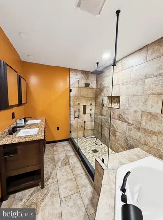 a bathroom with a granite countertop sink mirror and bathtub