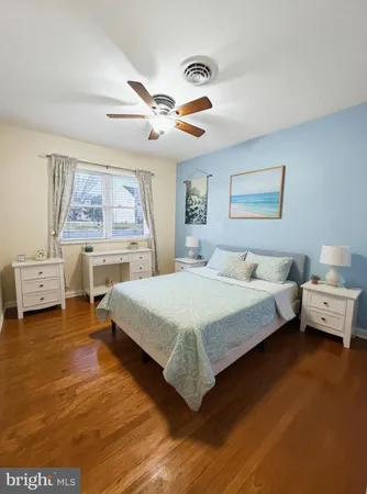 a spacious bedroom with a bed and a chandelier