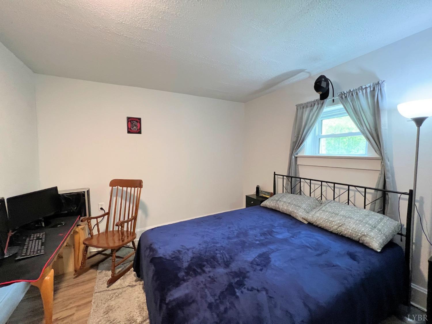 514 Smith Road Hurt, VA 24563 - Photo 34 of 59 a bedroom with a bed and a chair