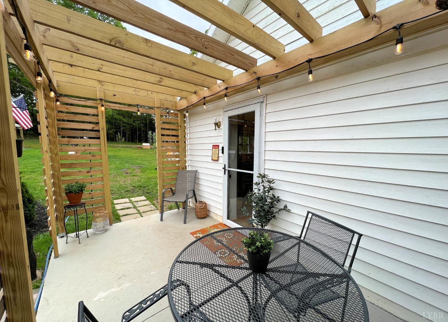514 Smith Road Hurt, VA 24563 - Photo 6 of 59 a patio with table and chairs and potted plants