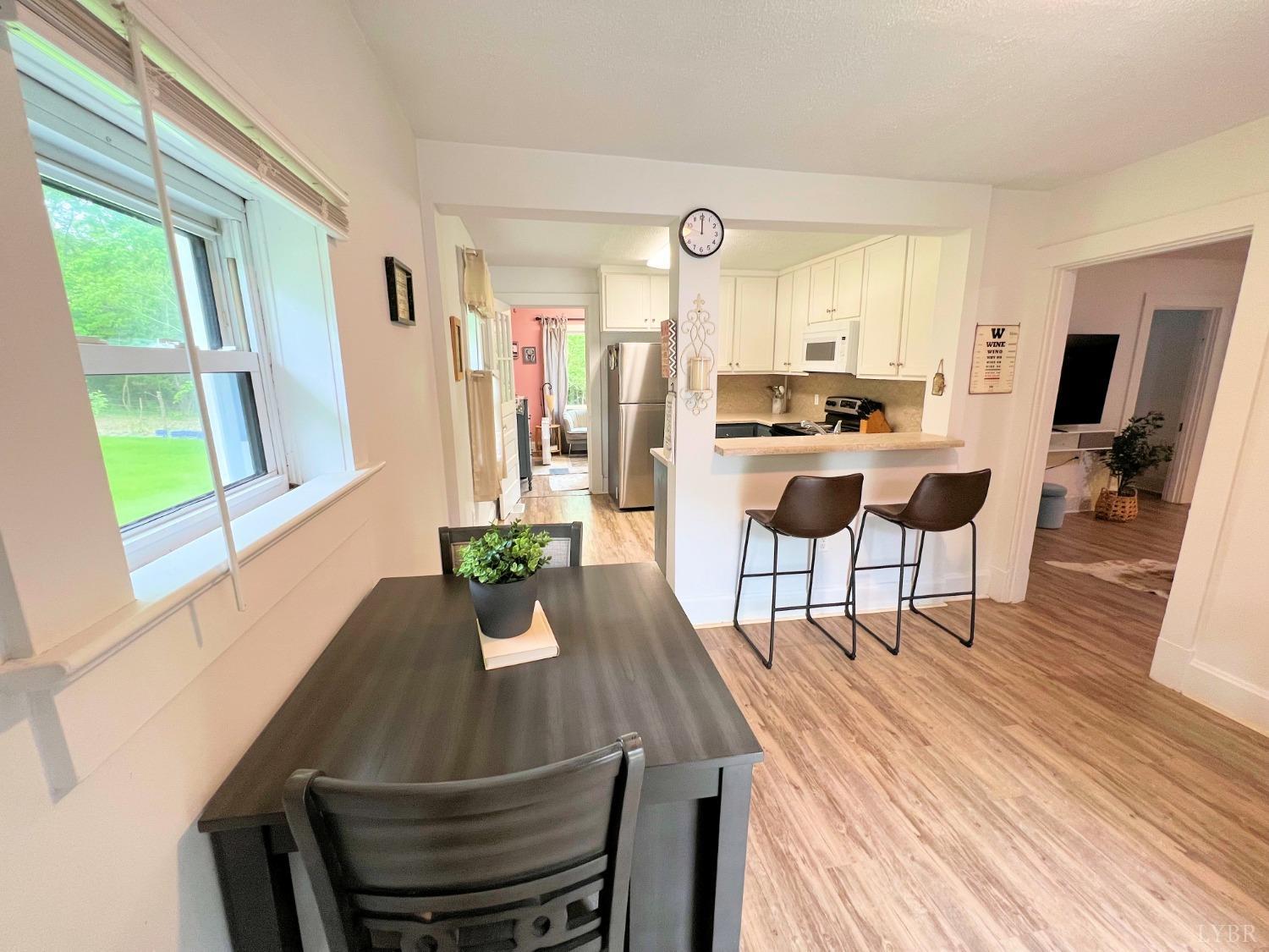 514 Smith Road Hurt, VA 24563 - Photo 8 of 59 a view of a dining room with furniture window and wooden floor