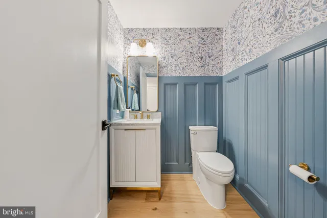 a bathroom with a toilet a sink and mirror