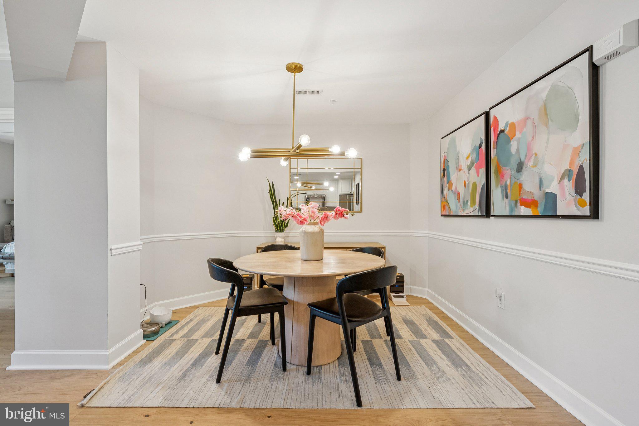 502 West Broad Street, Unit 215 Falls Church, VA 22046 - Photo 13 of 40 a view of a dining room with furniture wooden floor and a chandelier