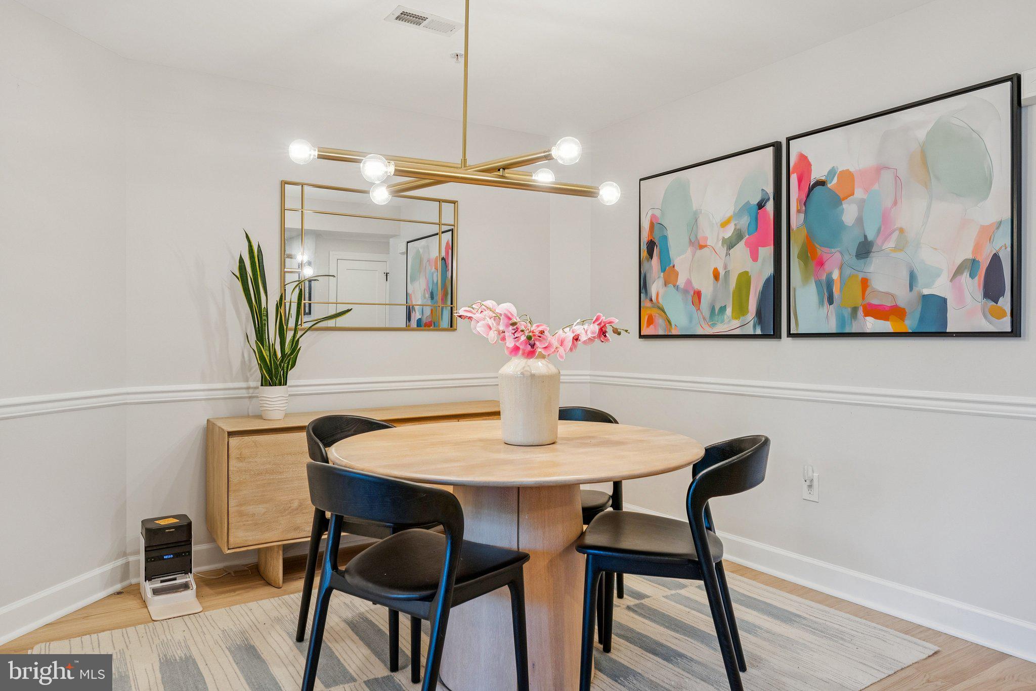 502 West Broad Street, Unit 215 Falls Church, VA 22046 - Photo 14 of 40 a view of a dining room with furniture a chandelier and wooden floor