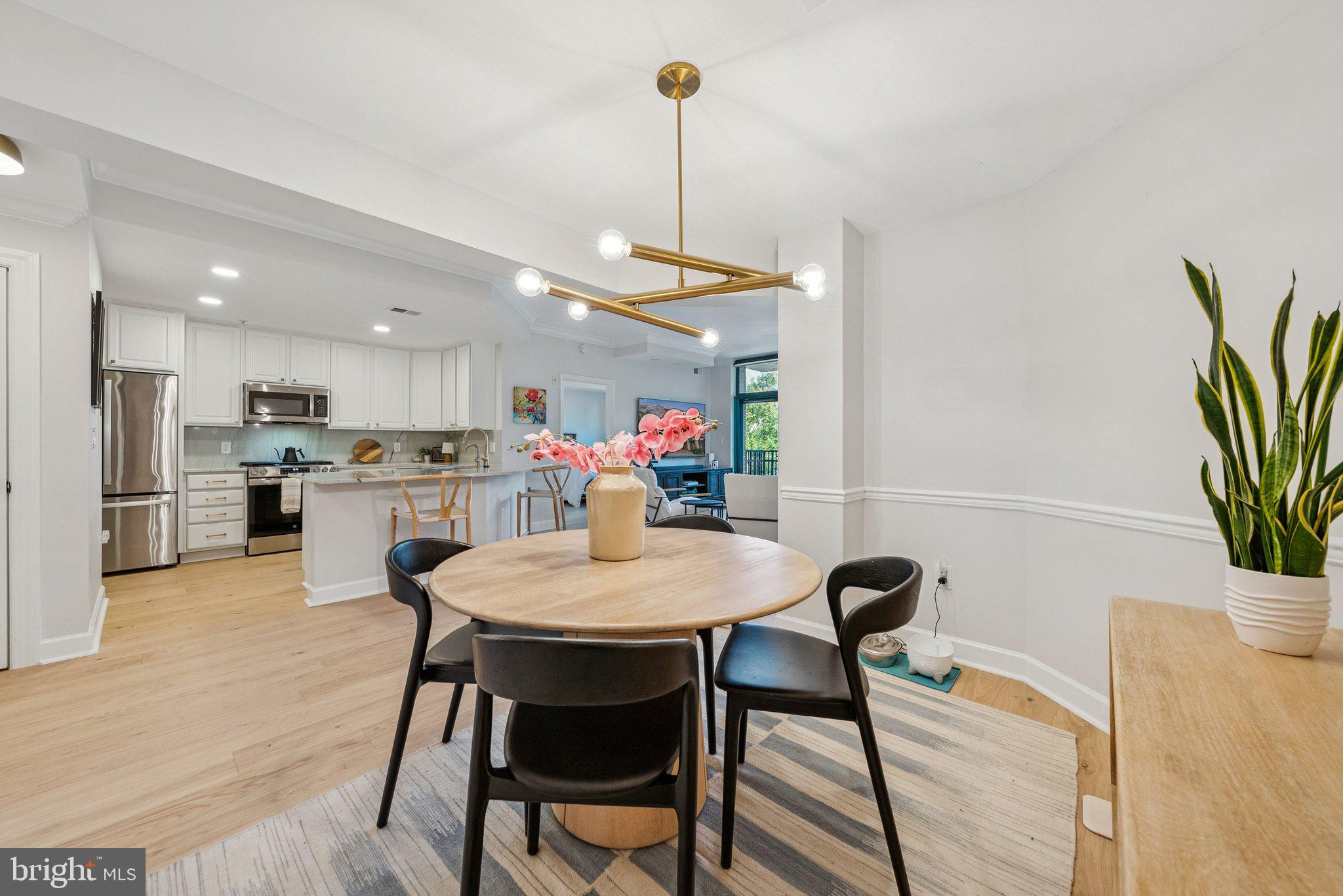 502 West Broad Street, Unit 215 Falls Church, VA 22046 - Photo 15 of 40 a view of a dining room with furniture and wooden floor