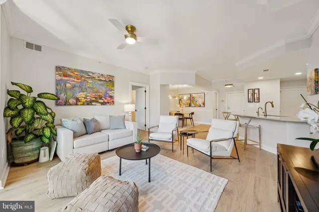 a living room with furniture and a painting on the wall