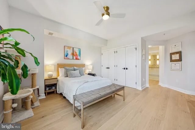 a spacious bedroom with a bed and a chandelier