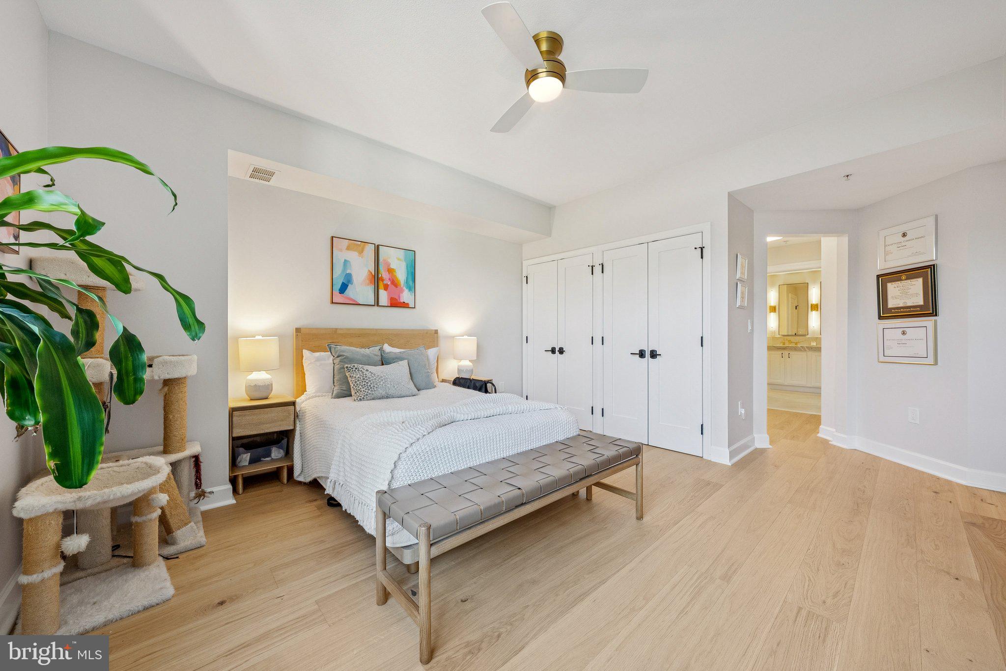 502 West Broad Street, Unit 215 Falls Church, VA 22046 - Photo 21 of 40 a spacious bedroom with a bed and a chandelier