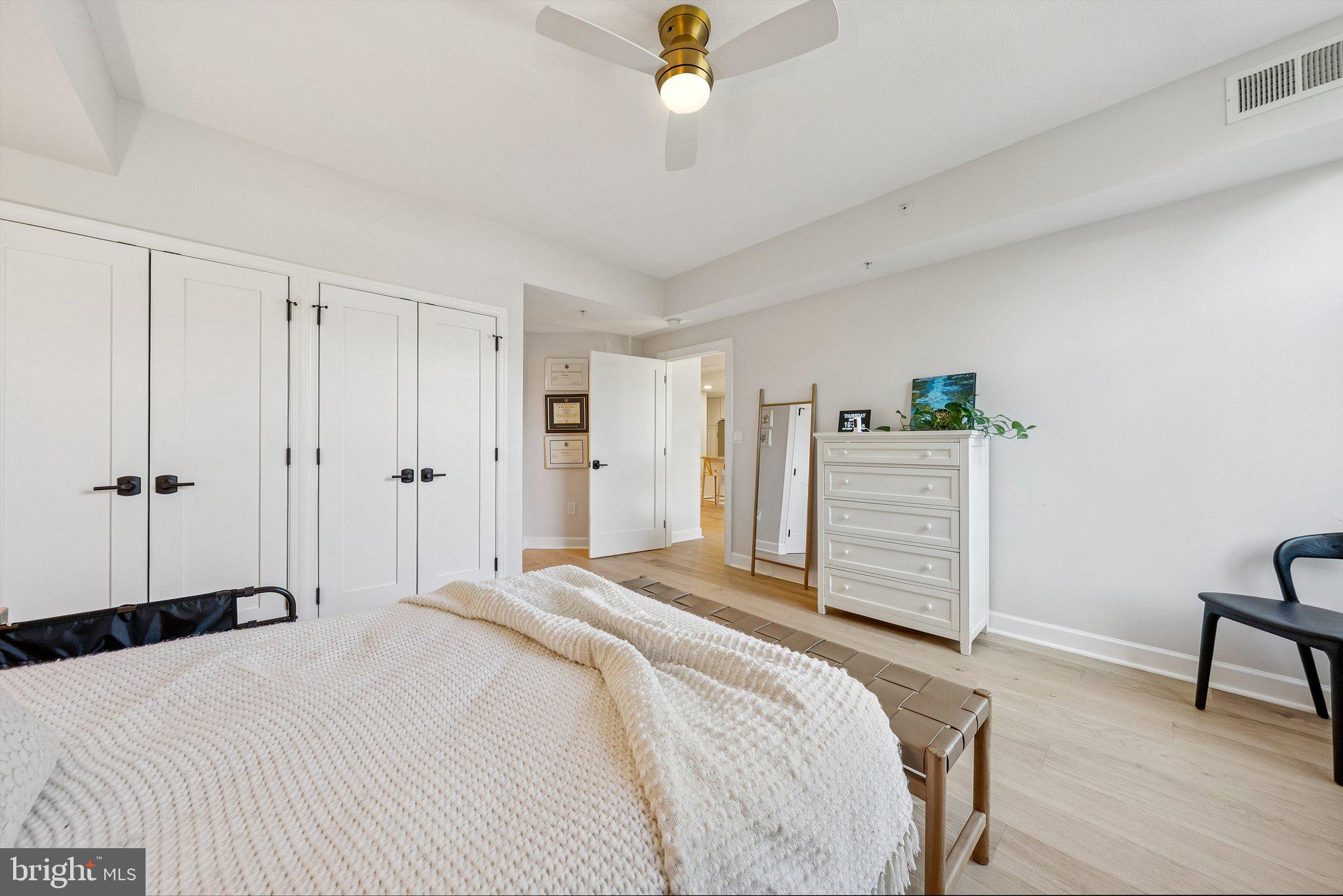 502 West Broad Street, Unit 215 Falls Church, VA 22046 - Photo 22 of 40 a bedroom with a bed and a chandelier