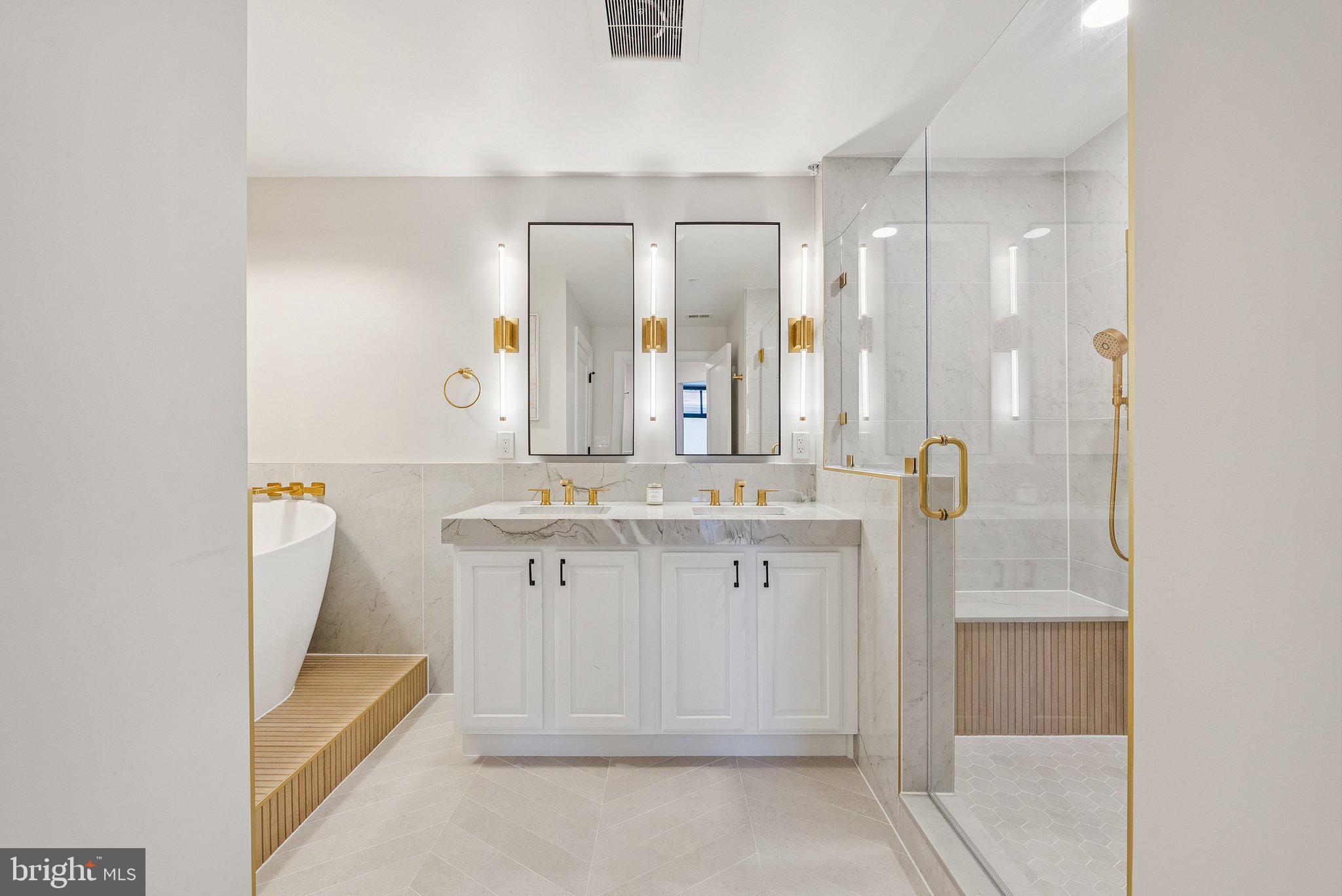 502 West Broad Street, Unit 215 Falls Church, VA 22046 - Photo 23 of 40 a bathroom with a double vanity sink and mirror