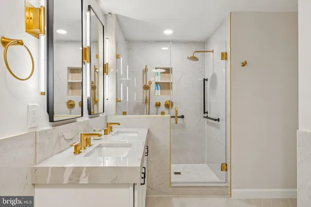 a bathroom with a sink mirror vanity and shower
