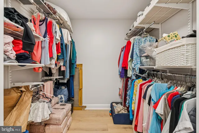 a view of walk in closet with clothes